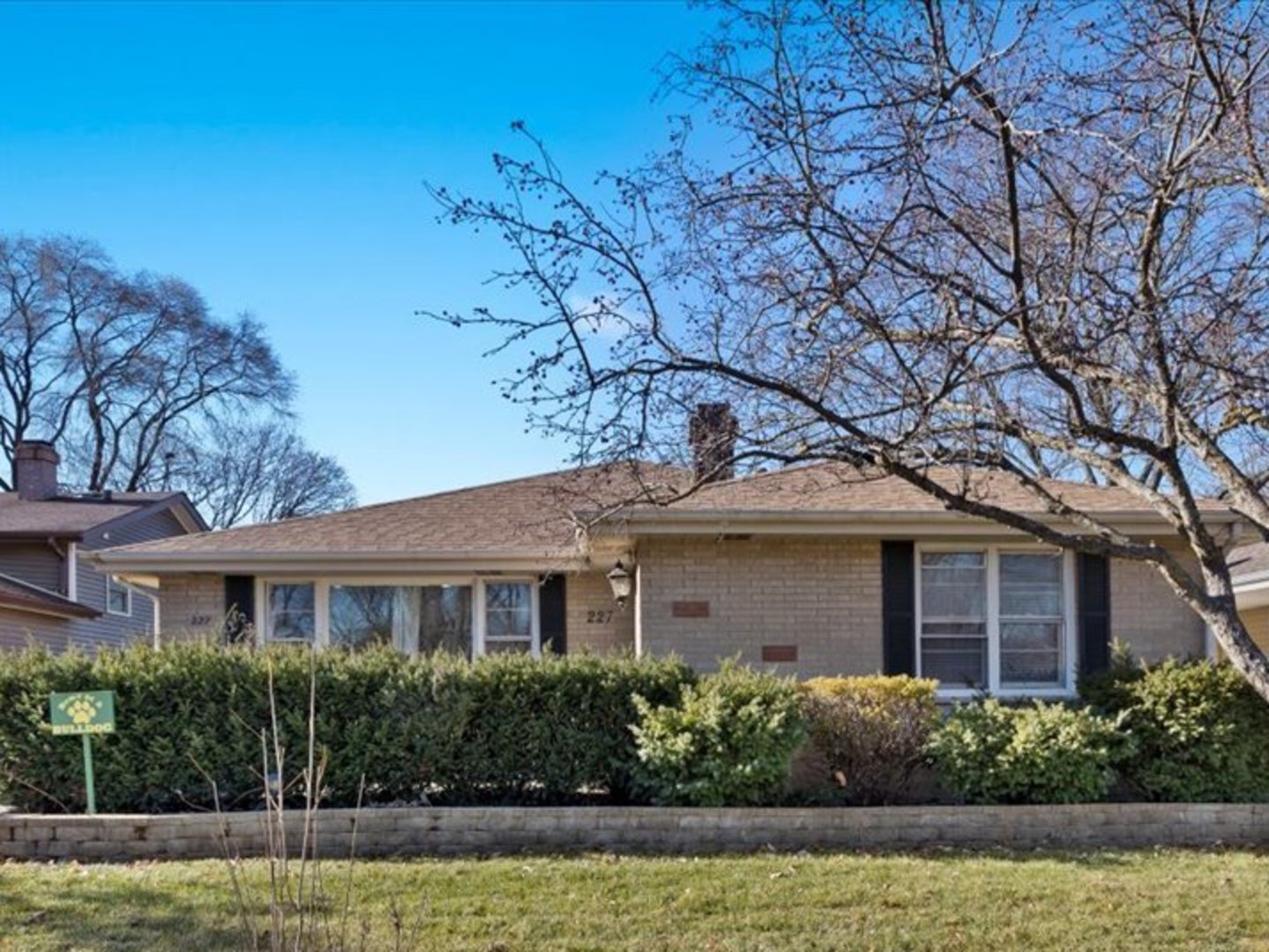 a front view of a house with a garden