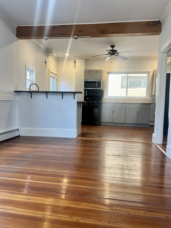 a view of a room with wooden floor and a window