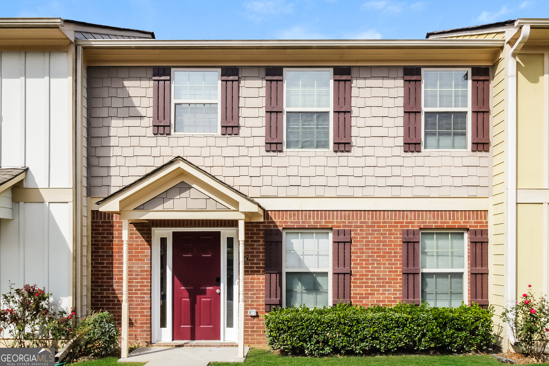 front view of a brick house with a small window