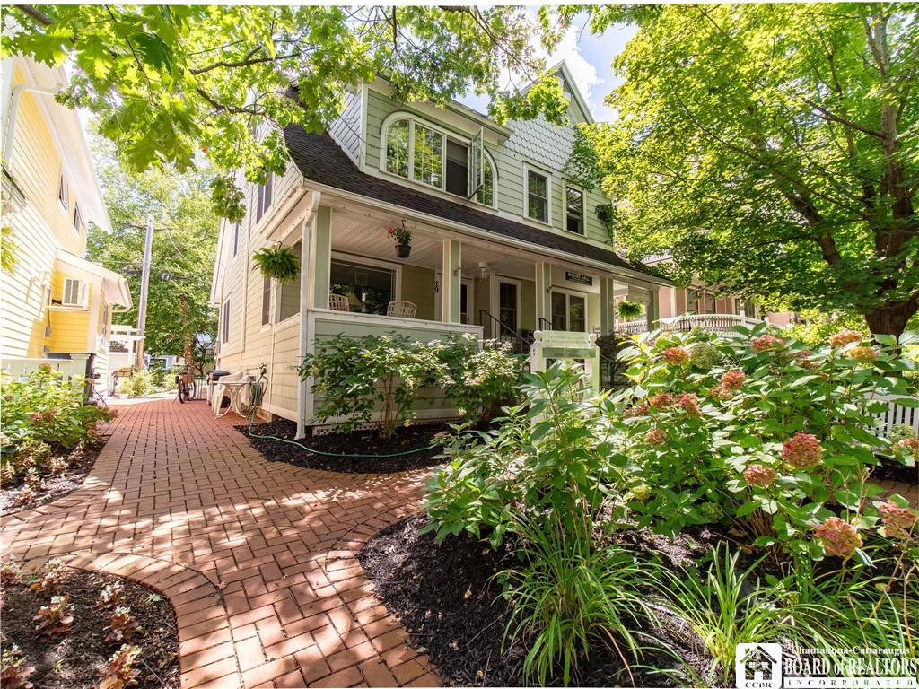 Lovely landscaping and brick walkway welcome you t