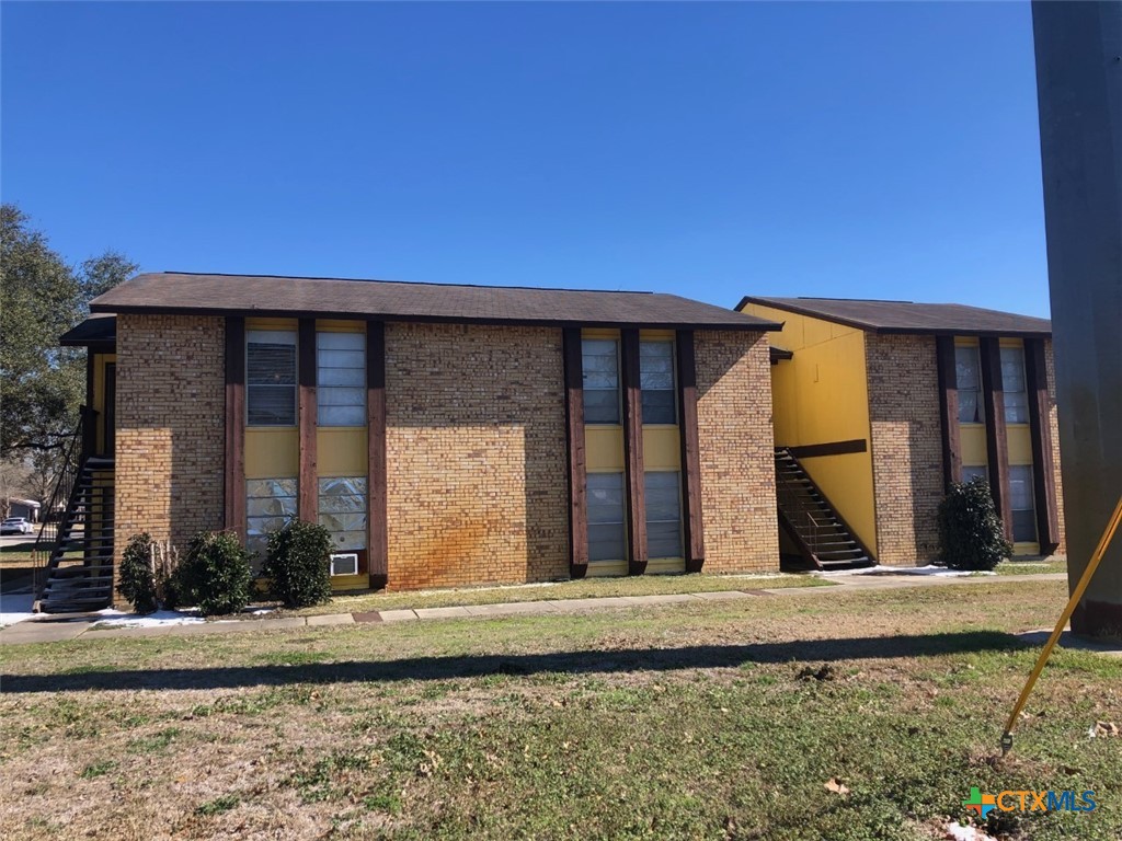 a view of a brick house with large windows