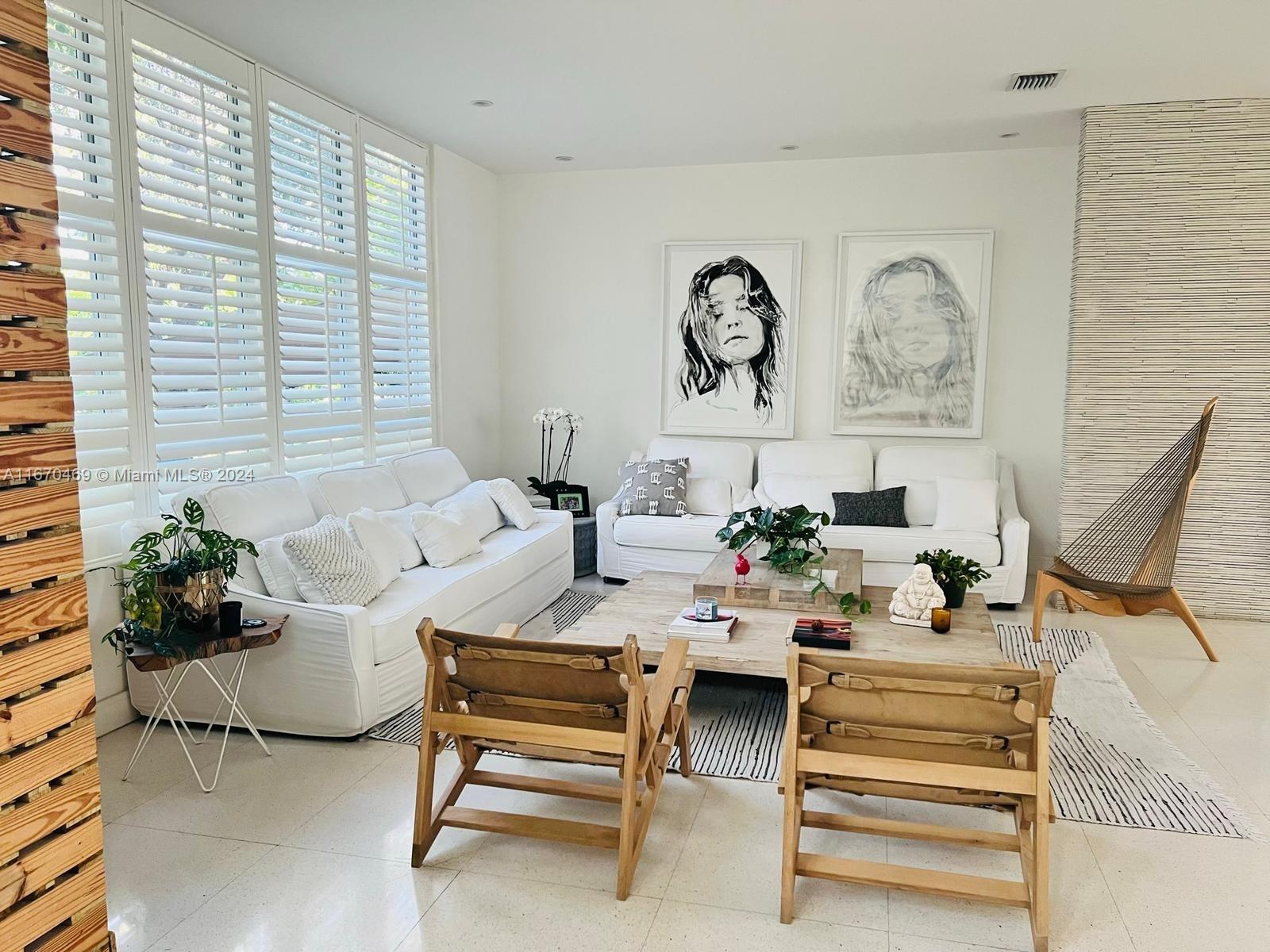 a living room with furniture and flowers