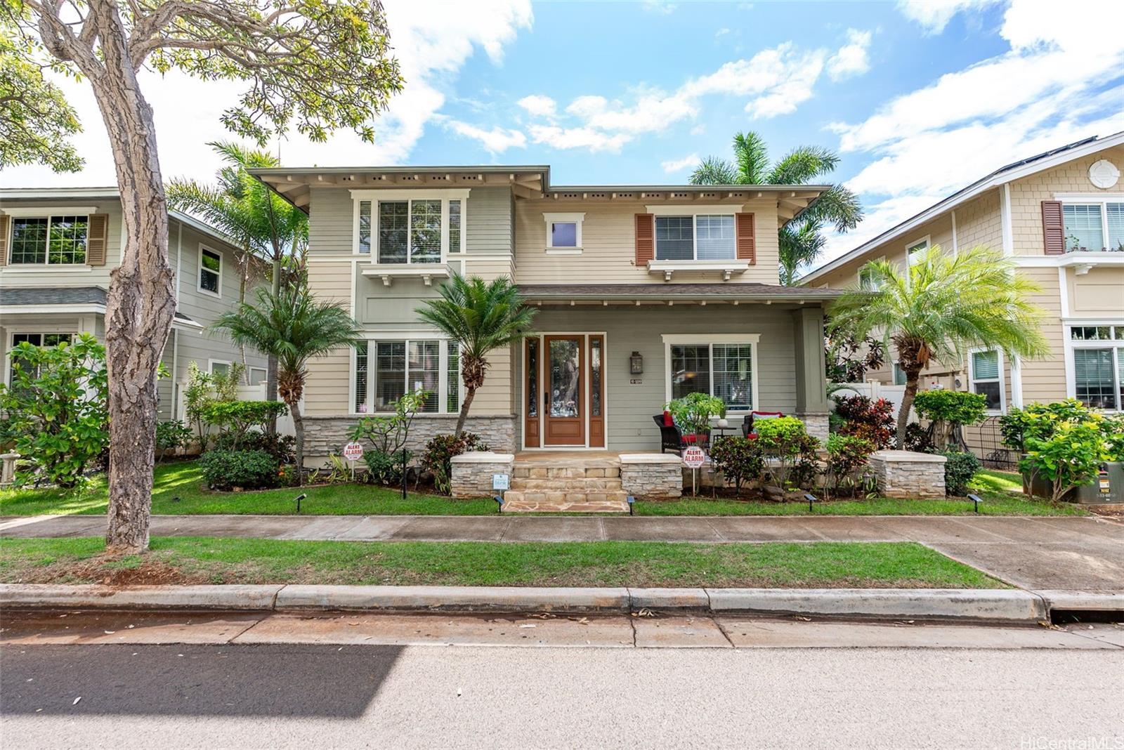 a front view of a house with a garden and plants