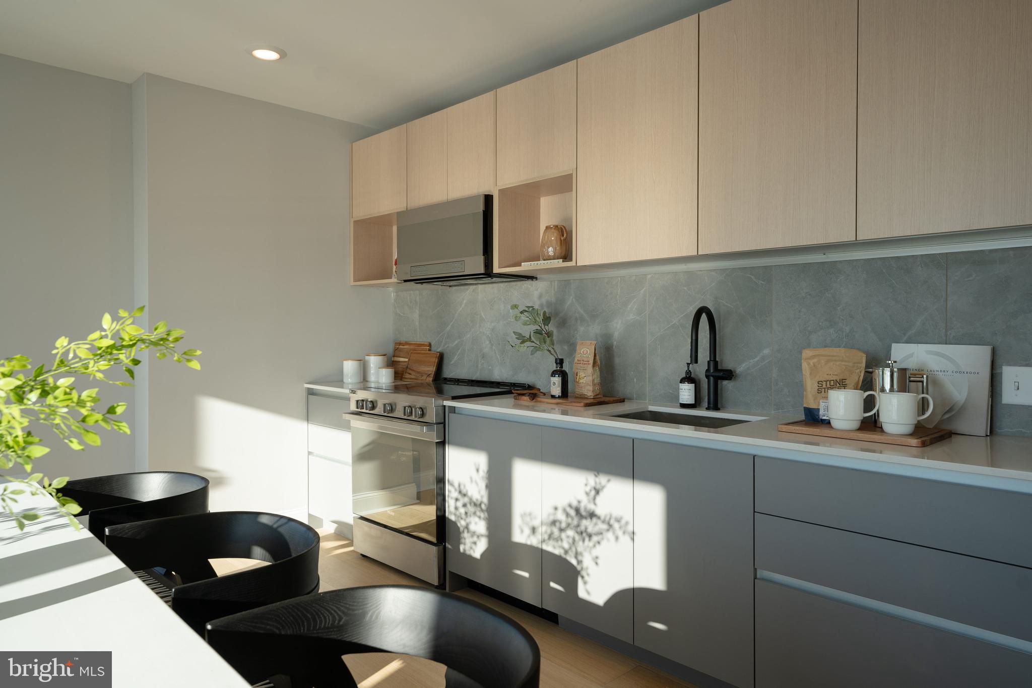 a kitchen with a sink a stove and cabinets