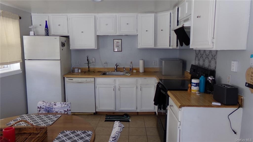 a kitchen with a sink a stove and refrigerator