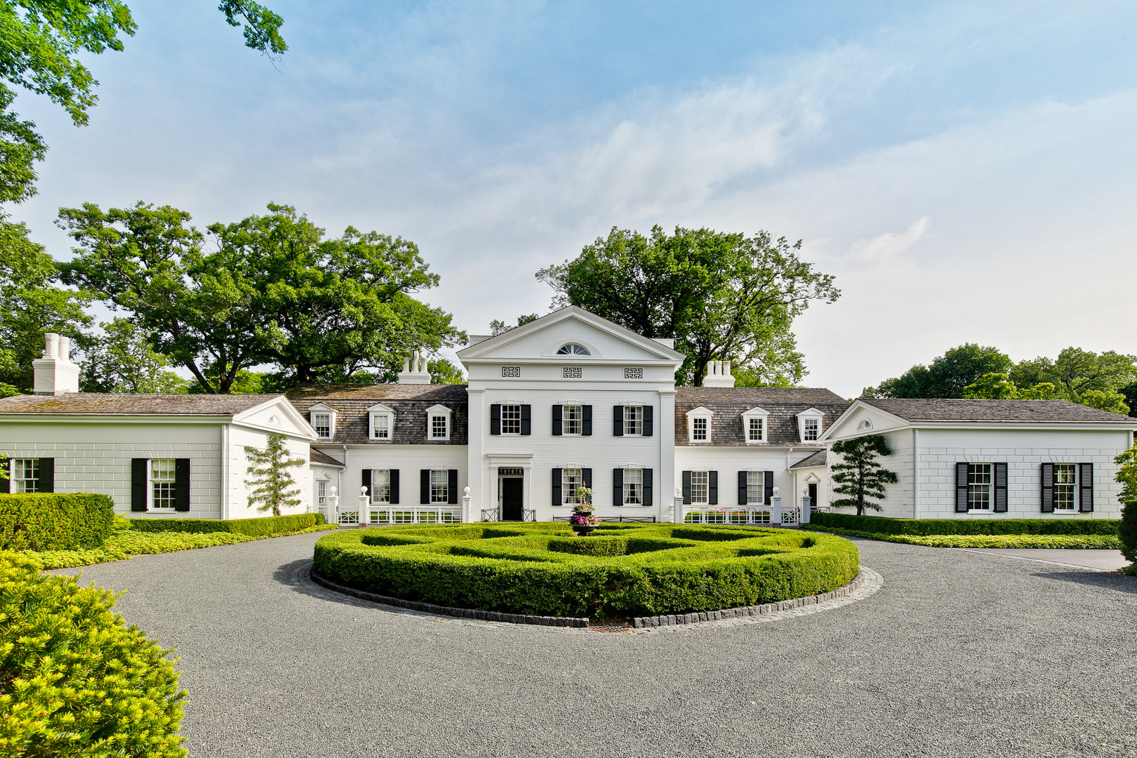 a front view of a house with a garden