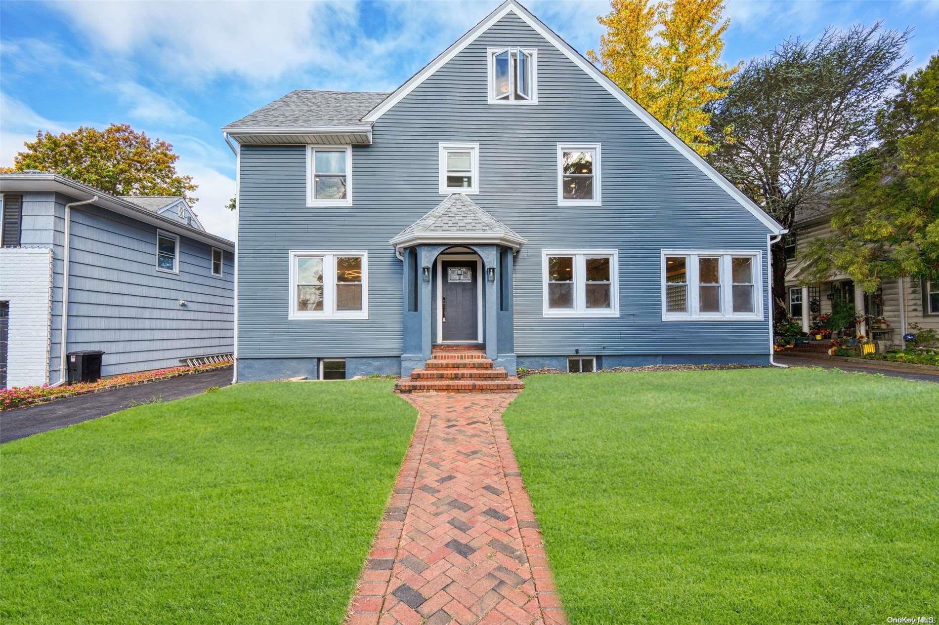 a front view of a house with a garden