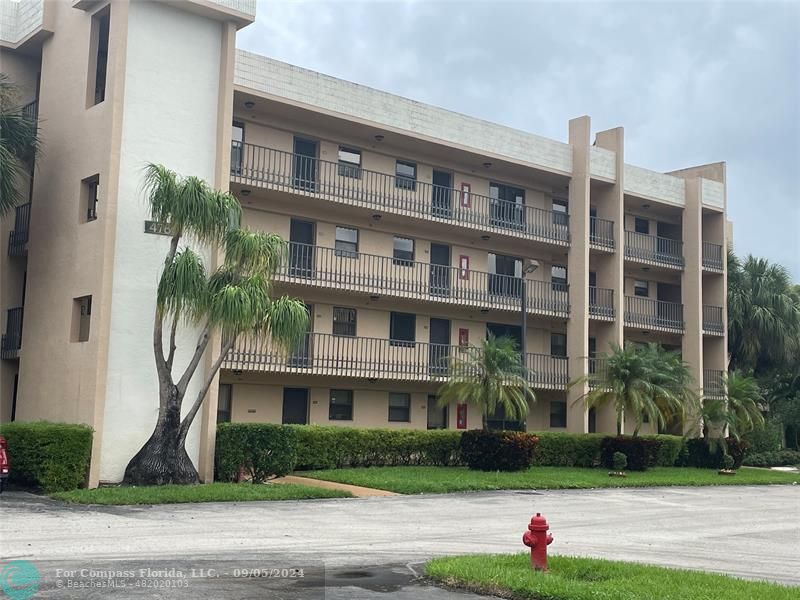 a front view of building with yard