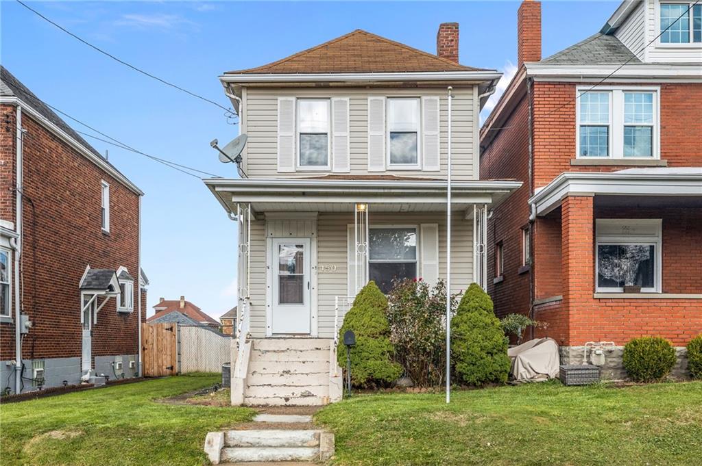 front view of a house with a yard