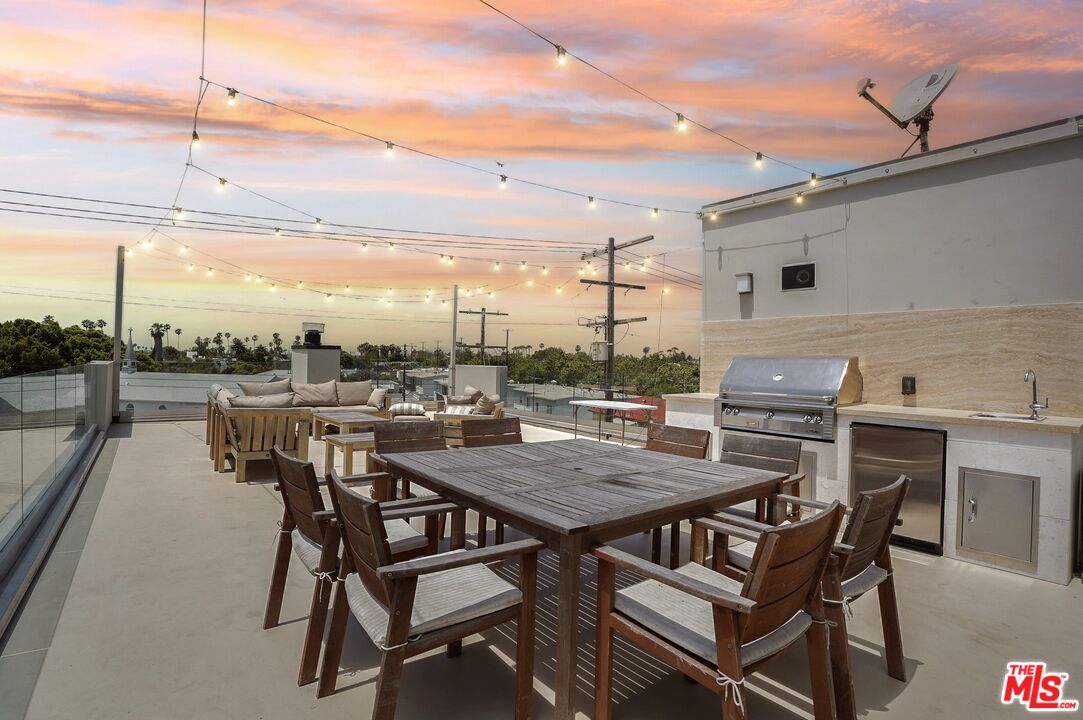 a view of a terrace with furniture and stove