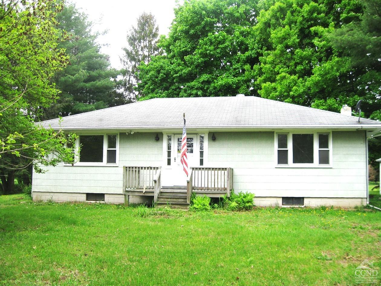 a view of house with backyard and garden