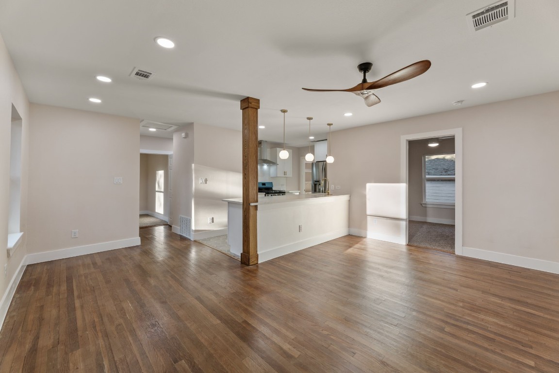 a view of a kitchen with wooden floor and a kitchen