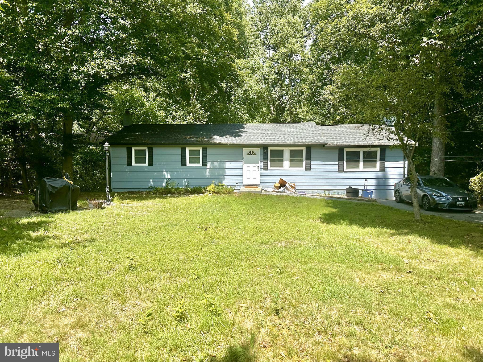 a front view of house with yard and trees