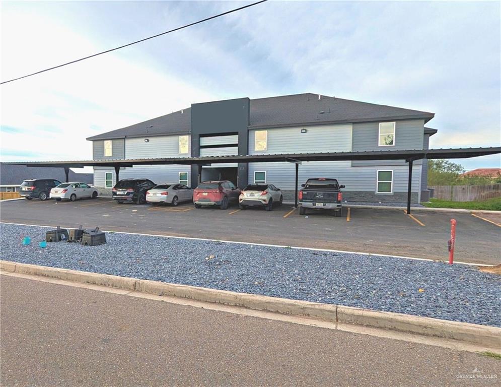 a view of a cars park in front of a building