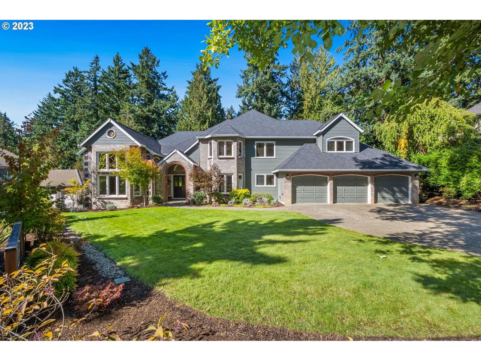 a front view of a house with a garden