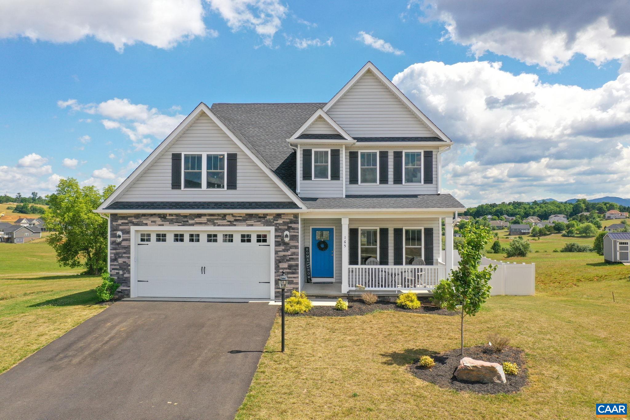 a front view of a house with a yard garage and outdoor seating