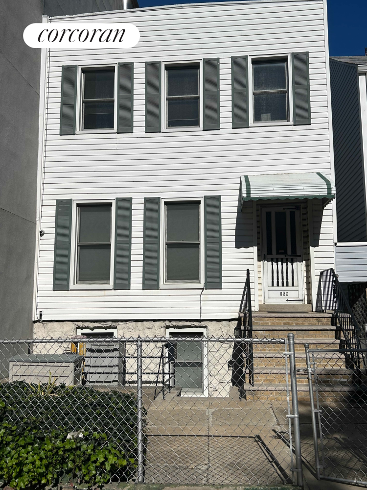 a view of a house with wooden fence