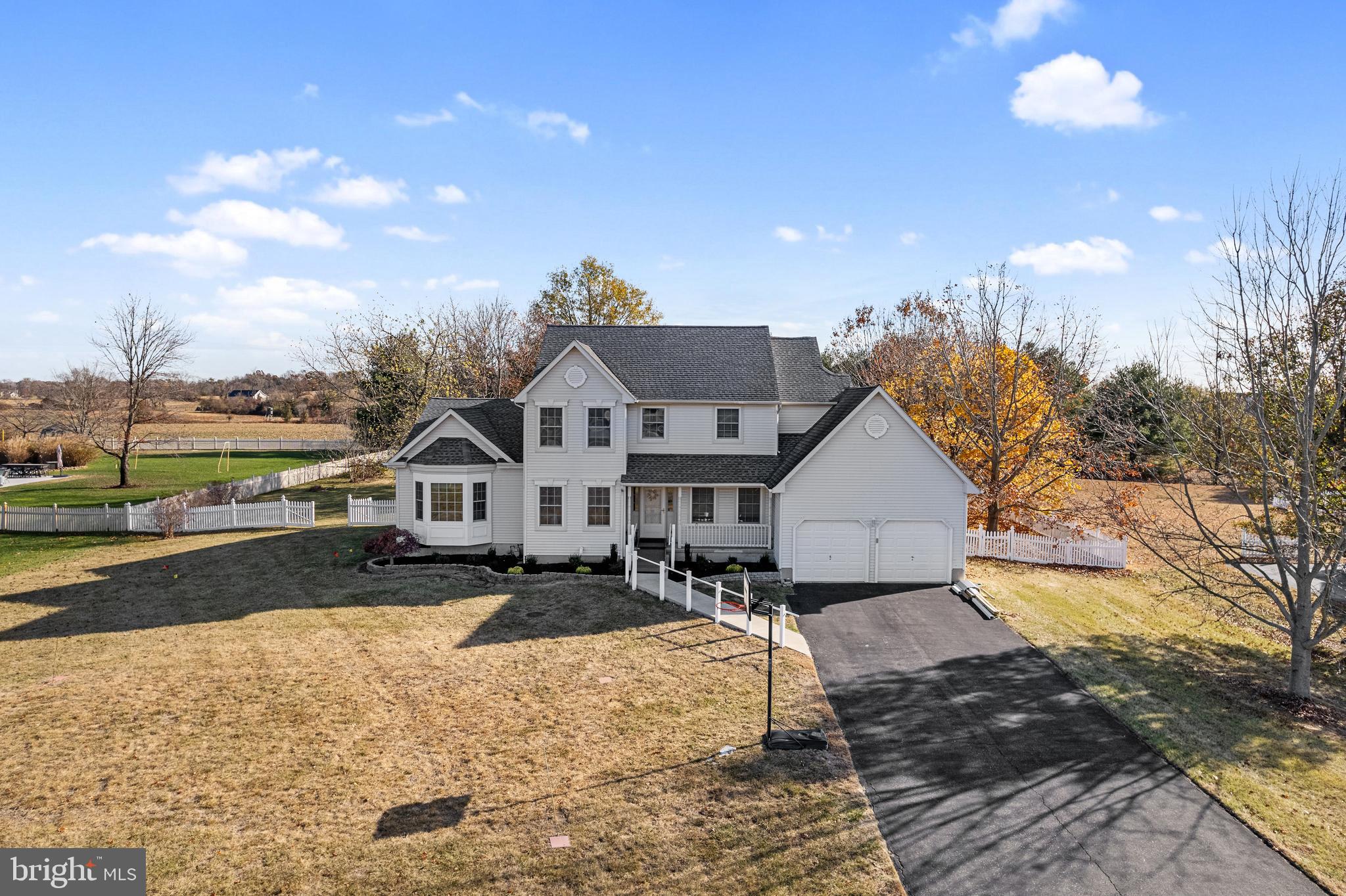 a front view of a house with a yard and mountain view