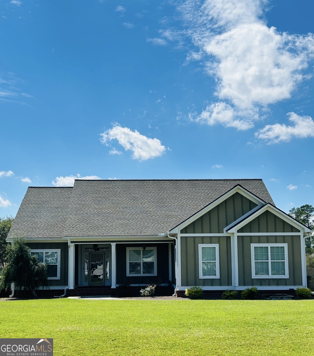 a front view of a house with a garden