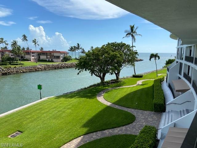 View of community with a water view and a yard