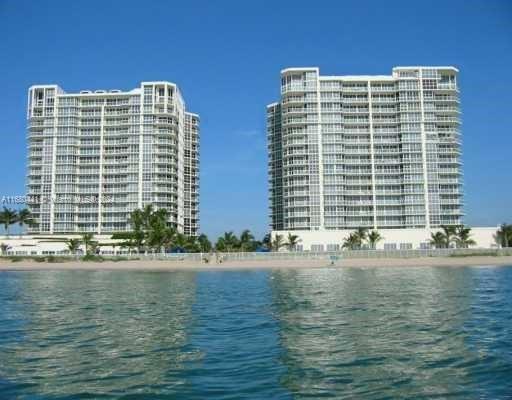 a front view of a building with lake and ocean view