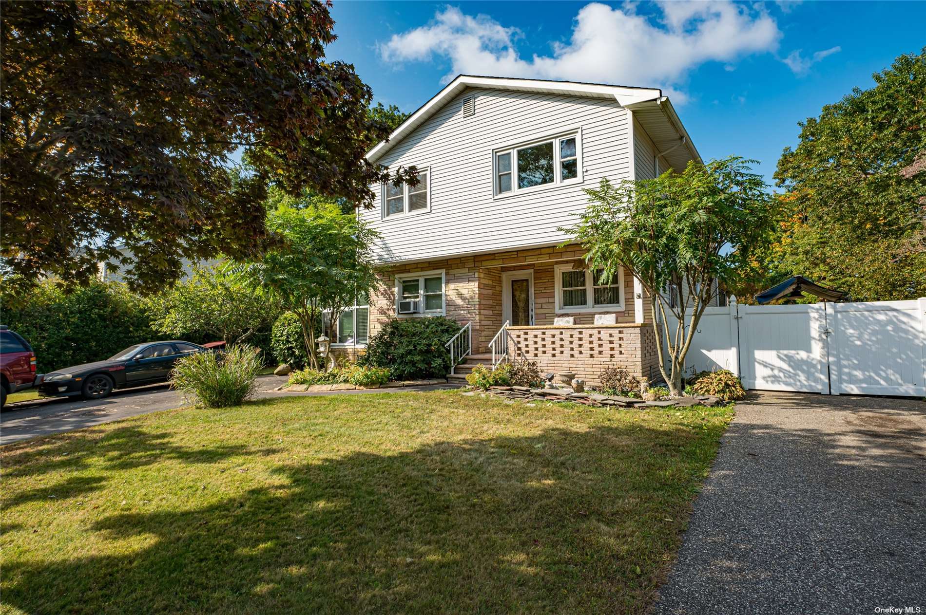 a front view of a house with yard and trees