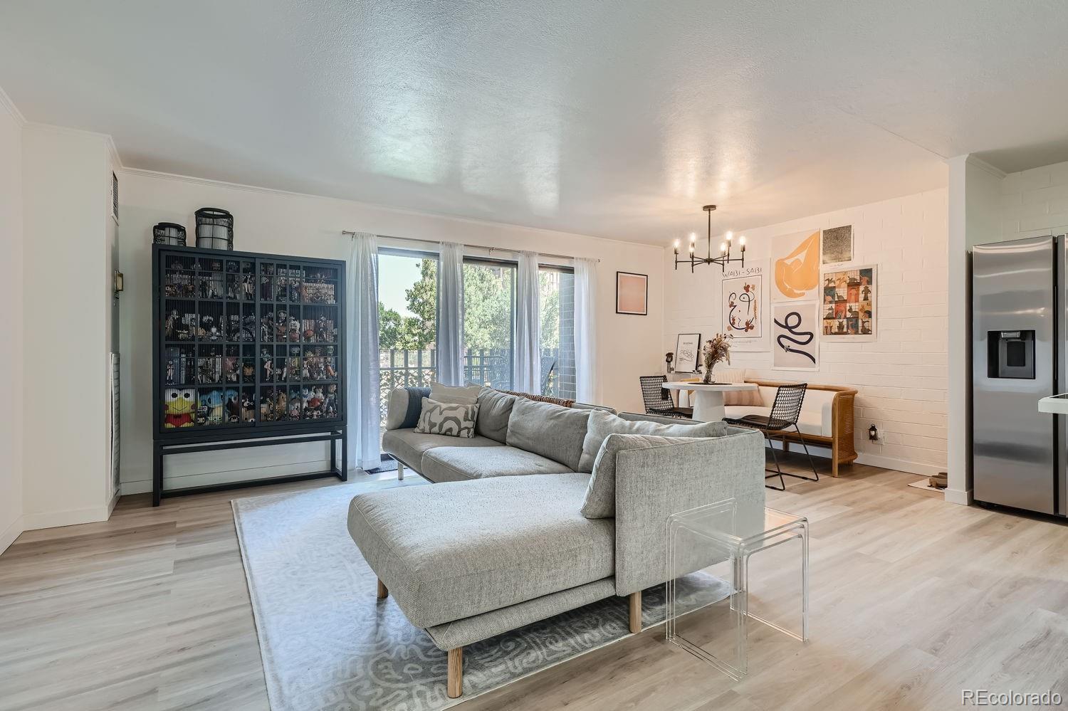 a living room with fireplace furniture and a wooden floor