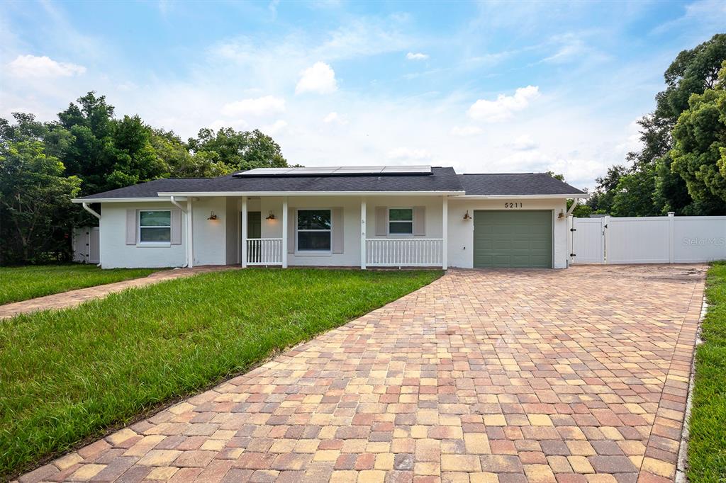 a view of house with a yard