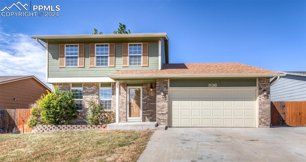 a front view of a house with a garage