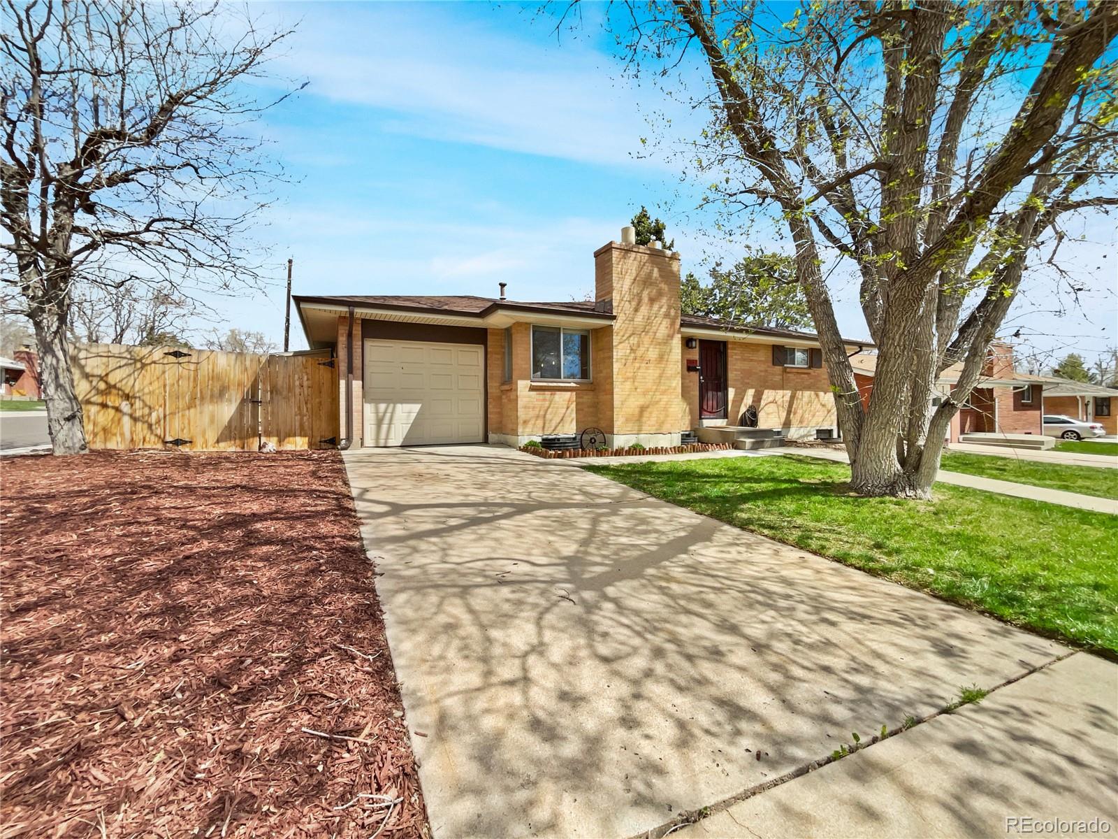 a front view of a house with a yard and trees