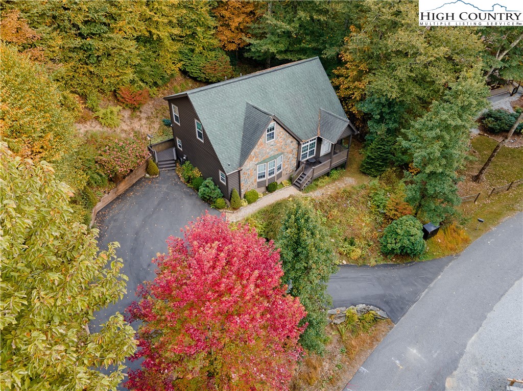 an aerial view of a house with a yard and a garden