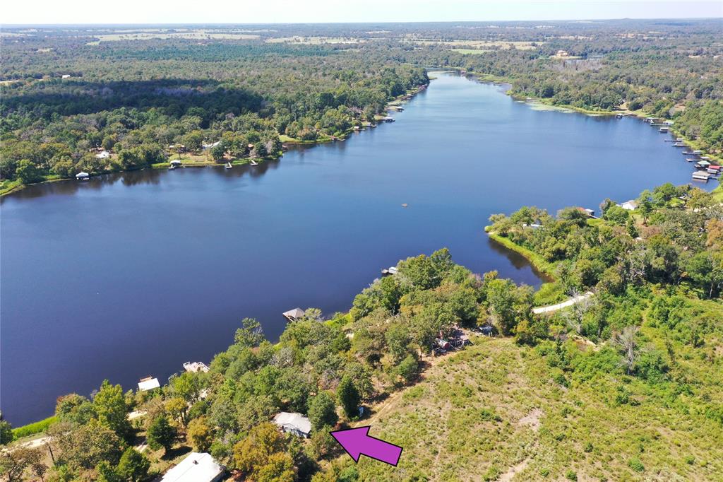 an aerial view of a house with a lake view