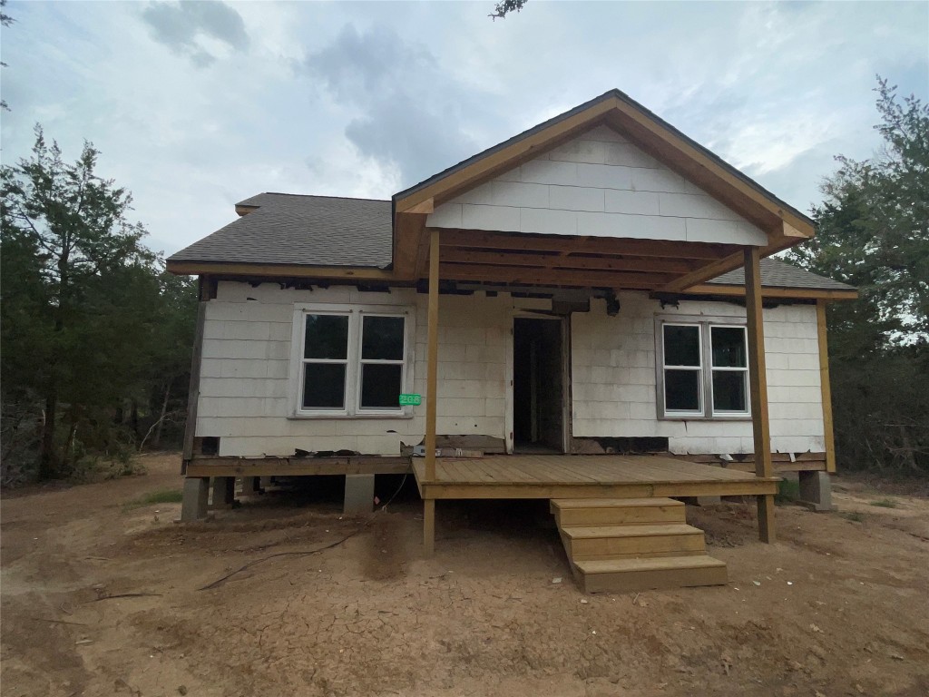 a front view of a house with outdoor seating