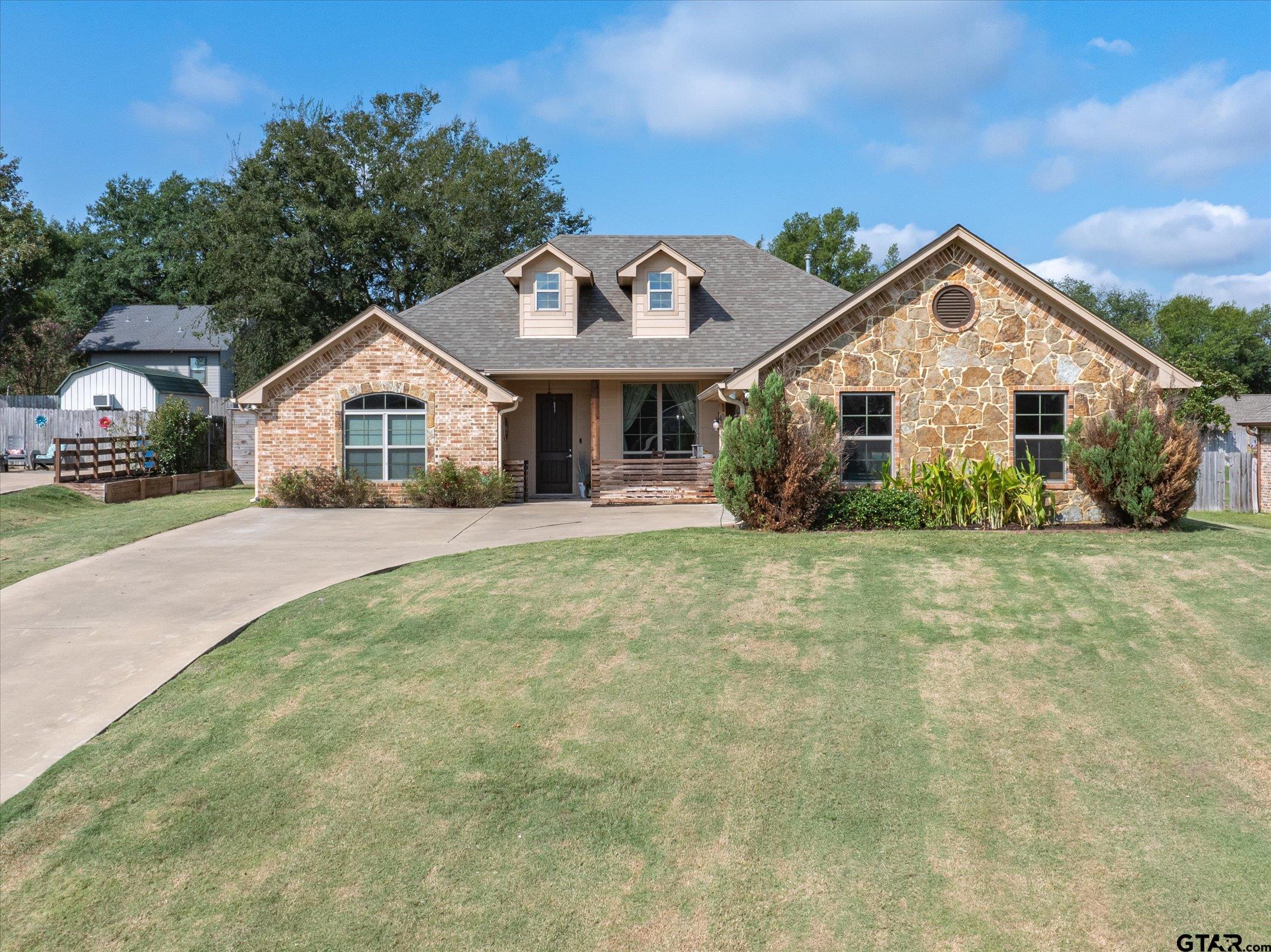 a view of house with yard and green space