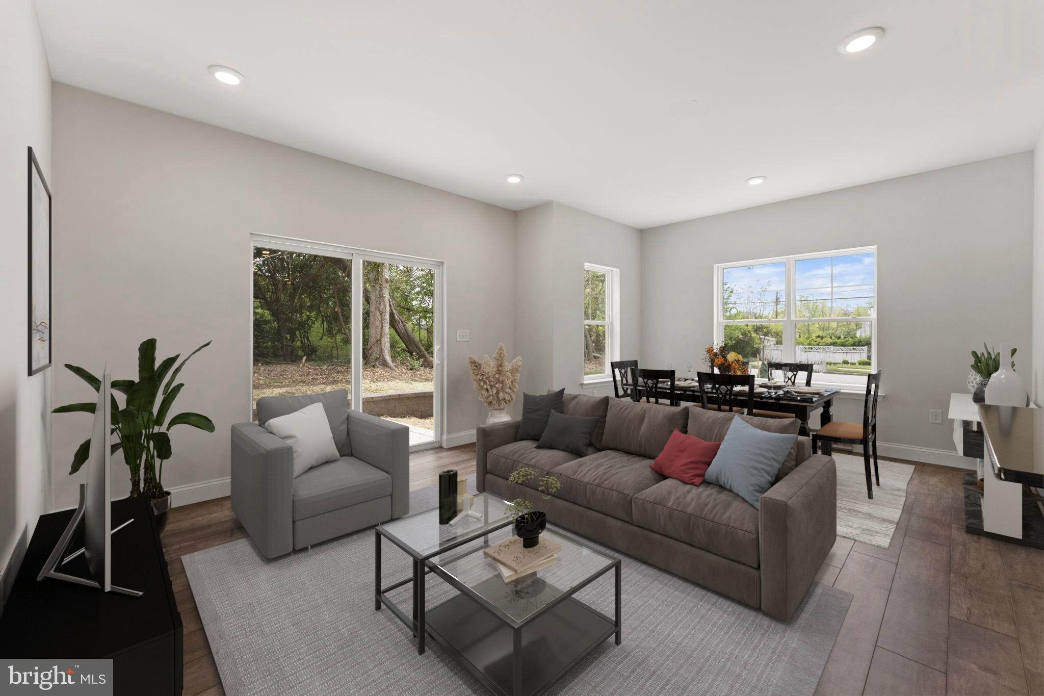 a living room with furniture potted plant and a large window