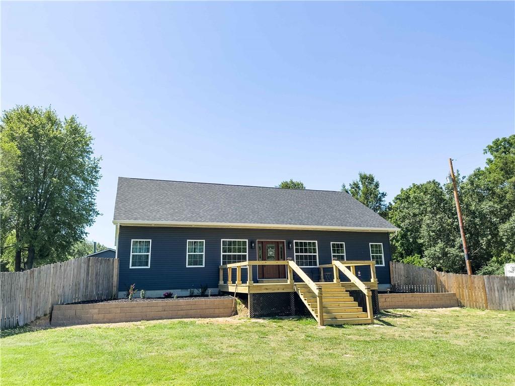 a view of a house with a yard and sitting area