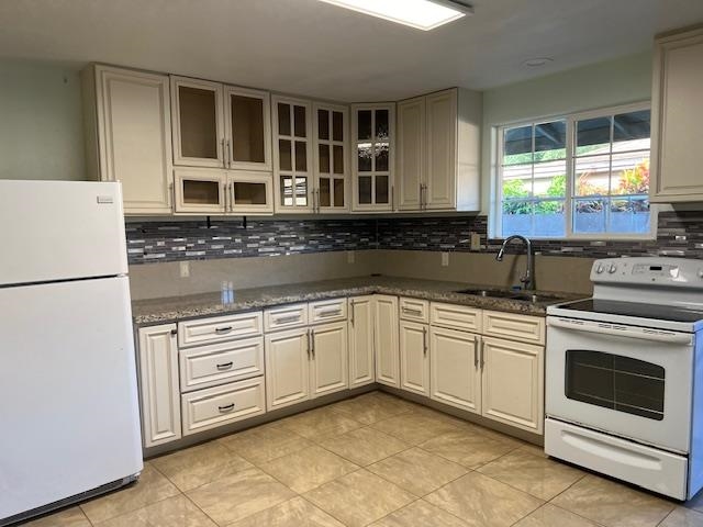 a kitchen with granite countertop cabinets stainless steel appliances and sink