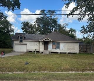 a front view of a house with a garden and yard