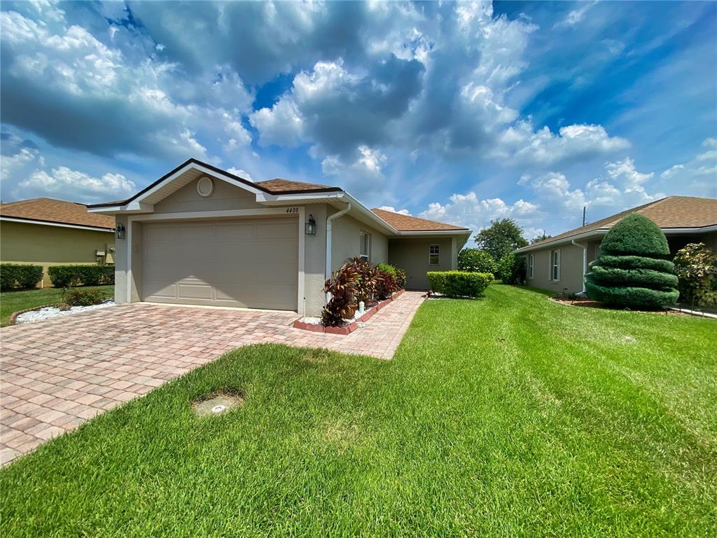 a front view of a house with a garden and yard