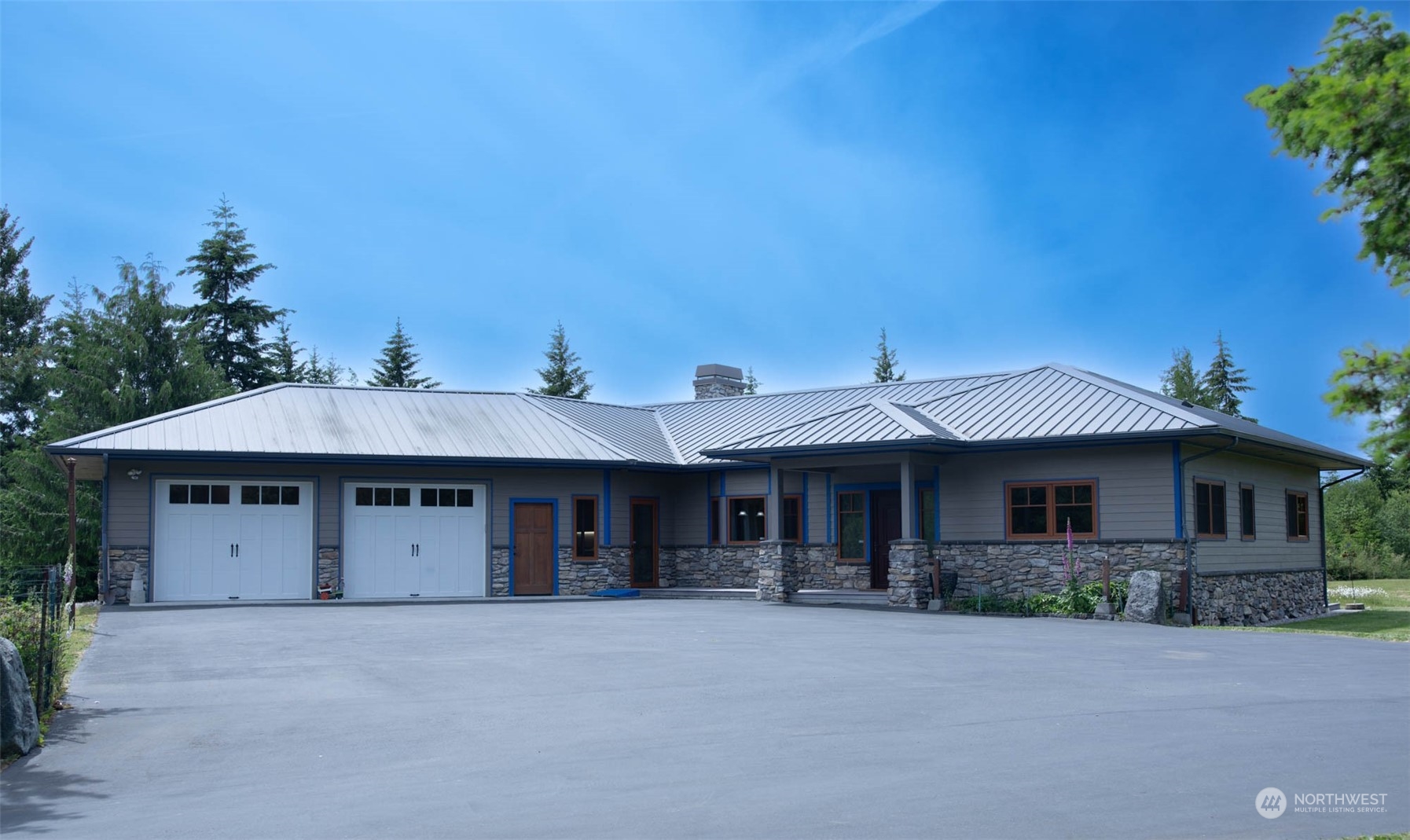 a front view of a house with yard and trees