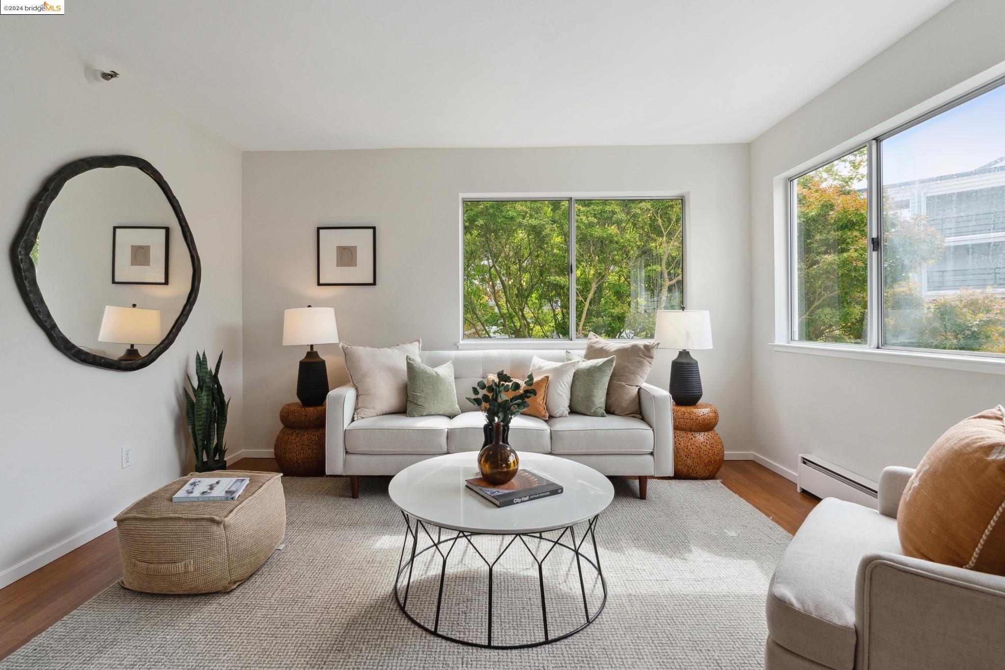 a living room with furniture and a large mirror