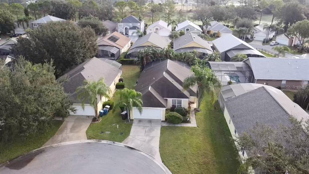 an aerial view of a house with garden space and street view