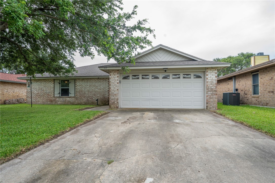 a front view of house with a yard and garage