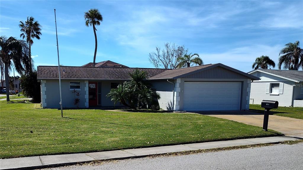 a front view of a house with a garden and yard