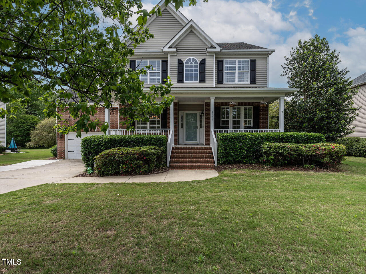 a view of house with yard and green space