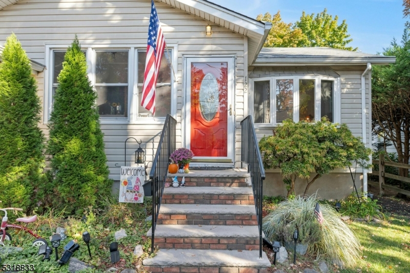 a front view of a house with a garden