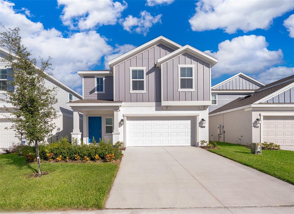 a front view of a house with a yard and garage