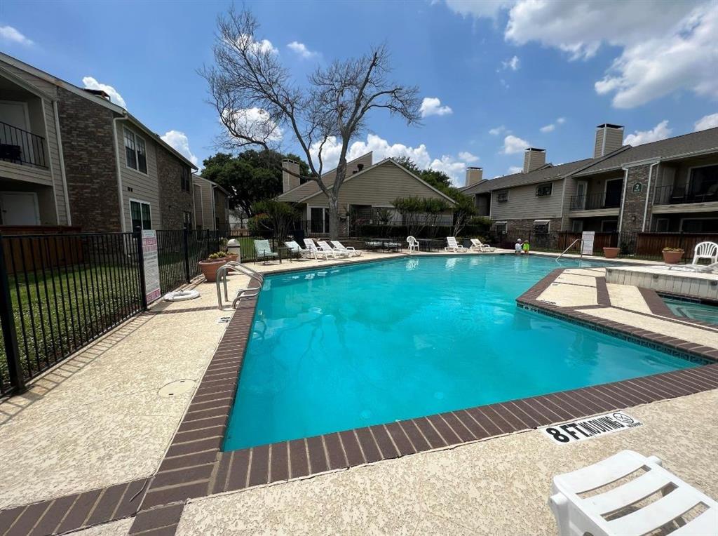 a view of a swimming pool with a patio