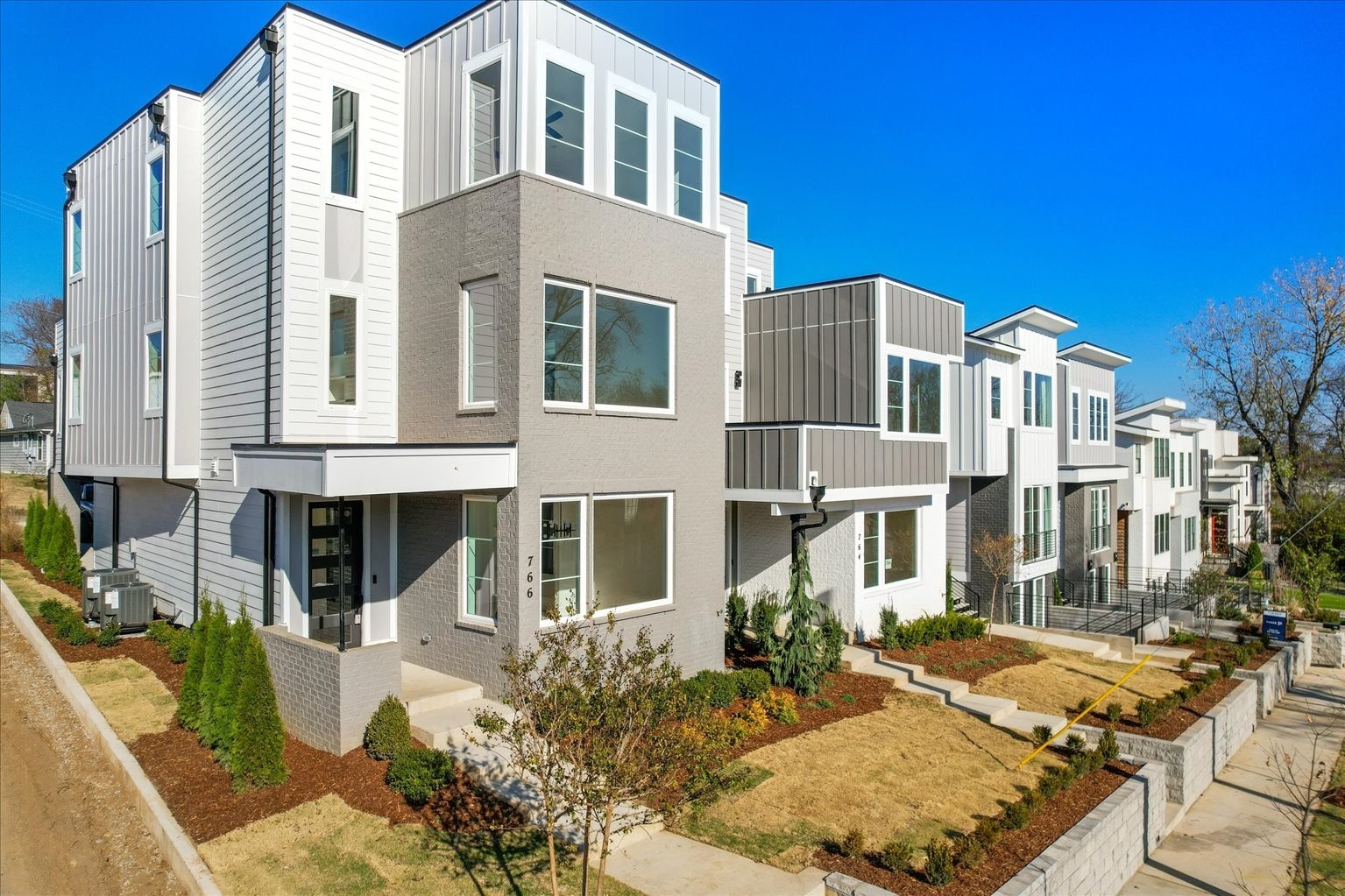 a front view of a residential apartment building with a yard