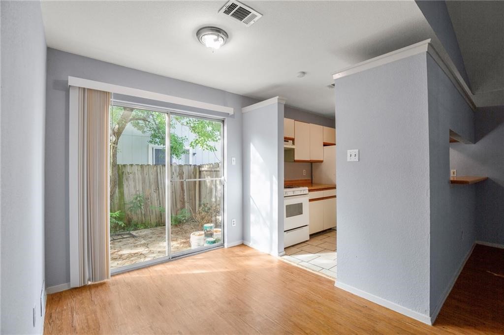 a room with window and a kitchen view